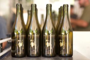 wine bottles with Reid Family Vineyard logo